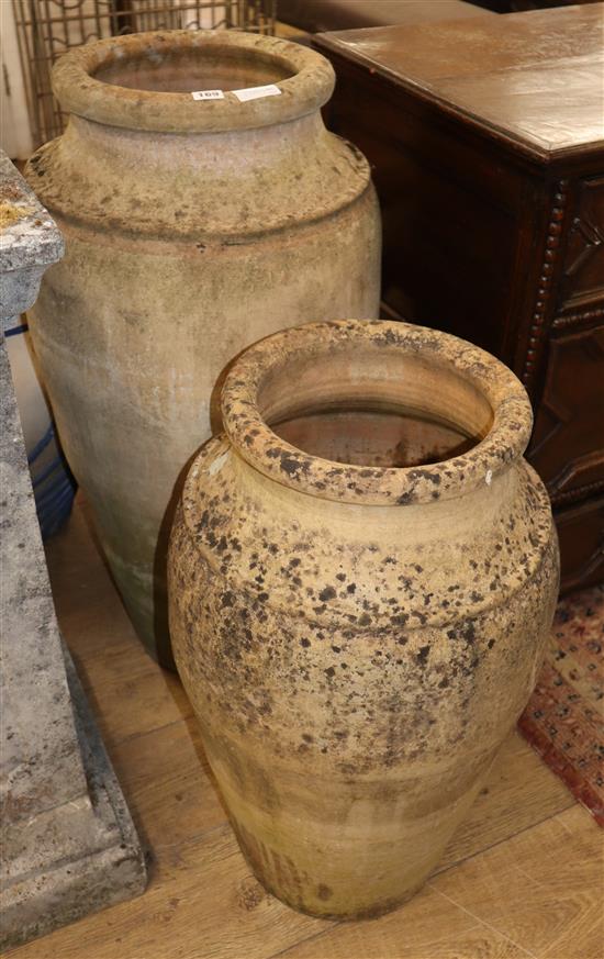 Two earthenware oil jars, largest H.92cm